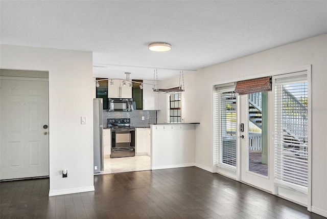 kitchen with french doors, backsplash, hardwood / wood-style floors, white cabinets, and black appliances