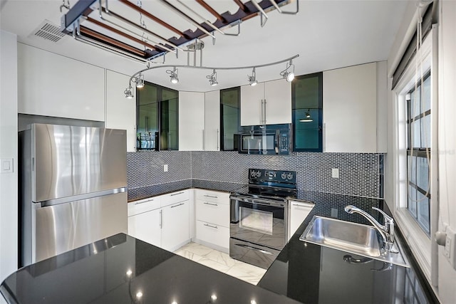 kitchen featuring sink, white cabinetry, stainless steel appliances, and tasteful backsplash