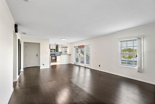 unfurnished living room featuring dark hardwood / wood-style flooring