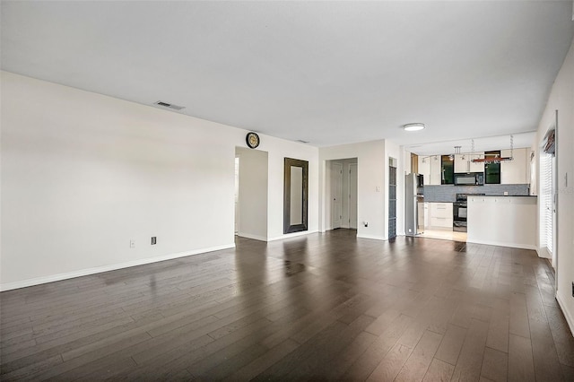 unfurnished living room with dark hardwood / wood-style floors