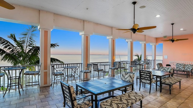 interior space featuring ceiling fan and a water view