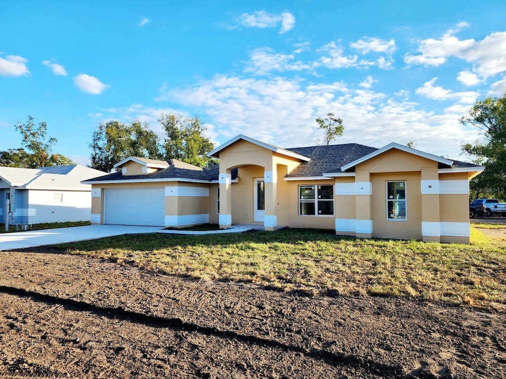 ranch-style home with a front yard and a garage