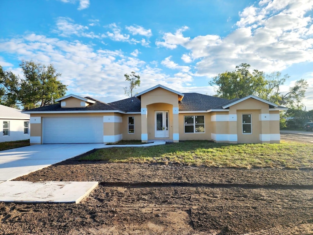 view of front facade with a front lawn and a garage