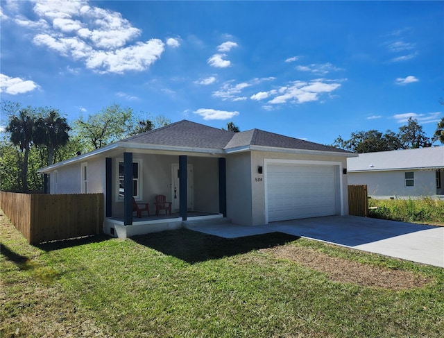 view of front of property with a front lawn, covered porch, and a garage