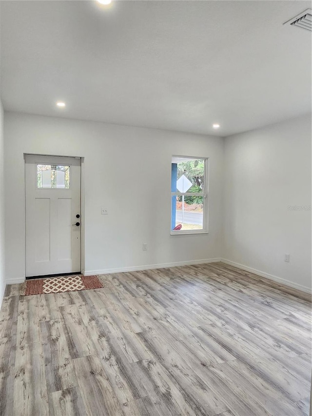 foyer entrance with recessed lighting, light wood-type flooring, visible vents, and baseboards