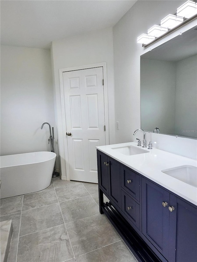5714 Olive Dr, New Port Richey, FL 34652 - full bath with a freestanding tub, double vanity, and tile patterned flooring