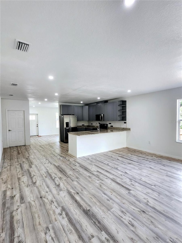 kitchen with visible vents, appliances with stainless steel finishes, open floor plan, light wood-style floors, and recessed lighting