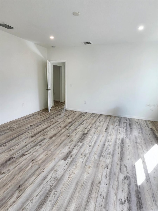 spare room featuring recessed lighting, visible vents, and light wood finished floors