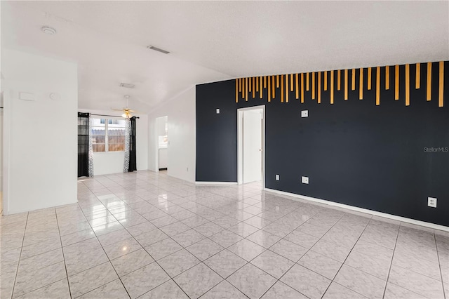 tiled spare room with ceiling fan and a textured ceiling