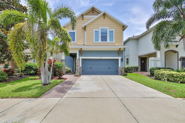 view of front of home featuring a garage and a front lawn