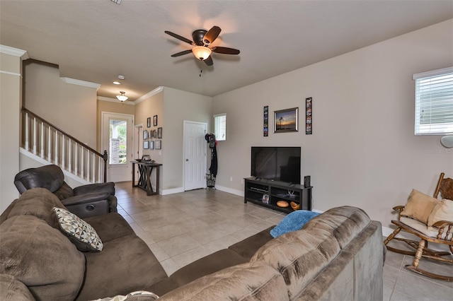 tiled living room featuring crown molding and ceiling fan