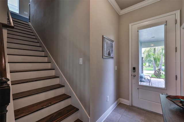 tiled entryway featuring ornamental molding