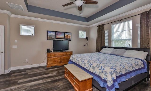 bedroom featuring a raised ceiling, ceiling fan, dark hardwood / wood-style flooring, and crown molding