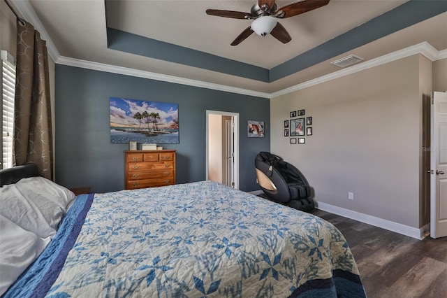 bedroom featuring ceiling fan, dark hardwood / wood-style floors, a raised ceiling, and ornamental molding