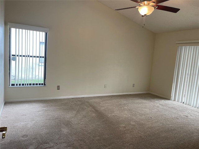 carpeted spare room featuring lofted ceiling and ceiling fan