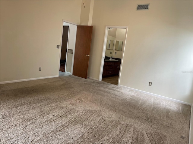 spare room featuring sink and carpet