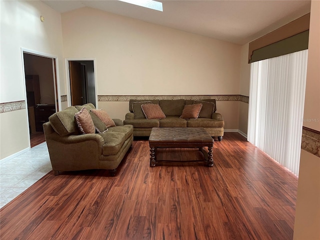 living room featuring hardwood / wood-style flooring and vaulted ceiling