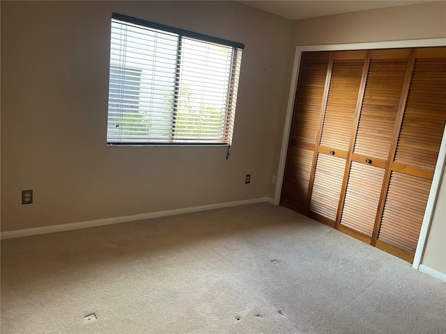 unfurnished bedroom with carpet floors and a closet