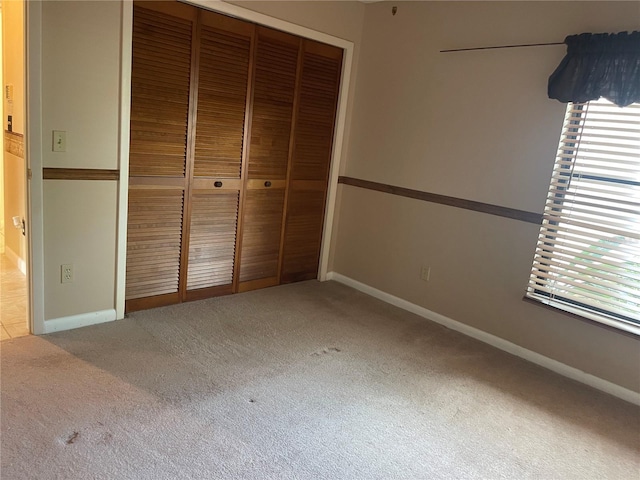 unfurnished bedroom with a closet and carpet