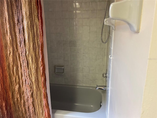 bathroom with shower / bath combo with shower curtain