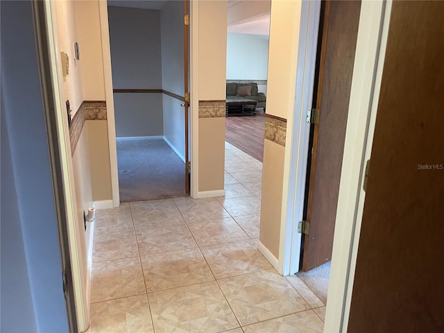 hall featuring light tile patterned floors