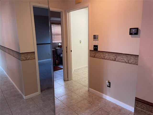 hallway featuring light tile patterned flooring