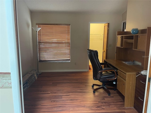 office space with dark wood-type flooring