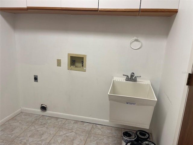 laundry room with cabinets, electric dryer hookup, hookup for a washing machine, and light tile patterned floors