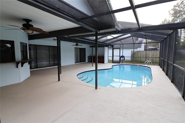 view of pool with a patio and glass enclosure