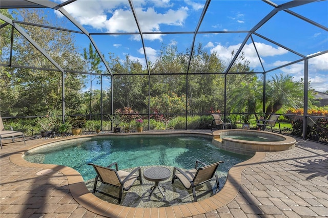 view of swimming pool featuring a lanai, an in ground hot tub, and a patio