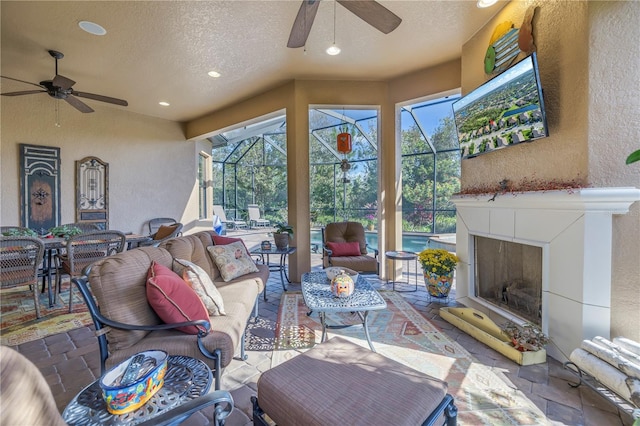 living room featuring ceiling fan, a healthy amount of sunlight, and a textured ceiling