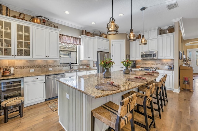 kitchen featuring white cabinets, a center island, and stainless steel appliances