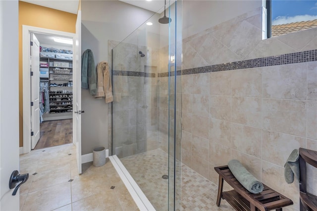 bathroom featuring tile patterned floors and tiled shower