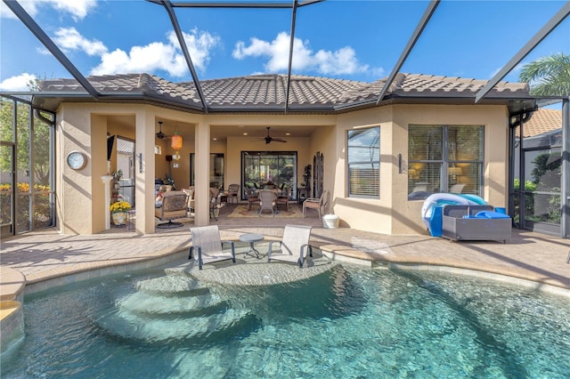 back of house with ceiling fan and a patio area