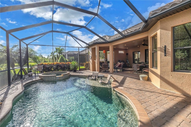 view of swimming pool with a lanai, ceiling fan, a patio area, and an in ground hot tub