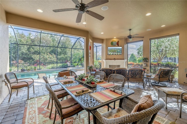 sunroom / solarium with ceiling fan and a pool