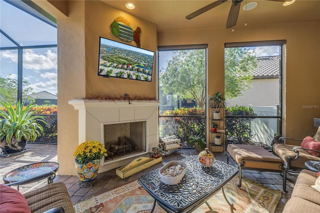 living room featuring a fireplace and ceiling fan