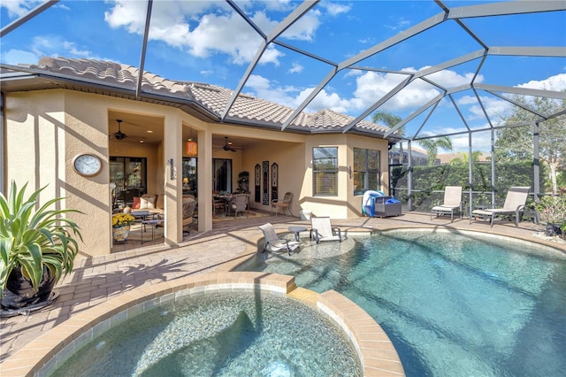 view of swimming pool with ceiling fan, a lanai, an in ground hot tub, and a patio