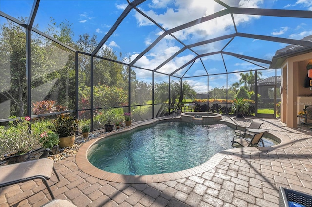 view of swimming pool featuring a patio area, an in ground hot tub, and glass enclosure