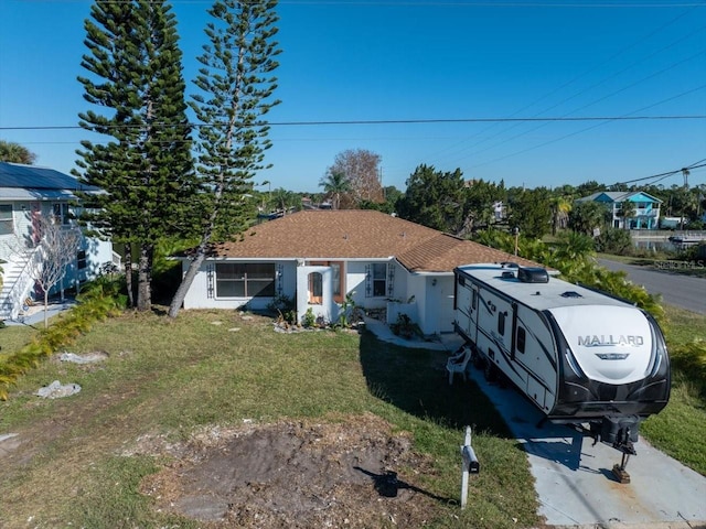 rear view of property with a yard