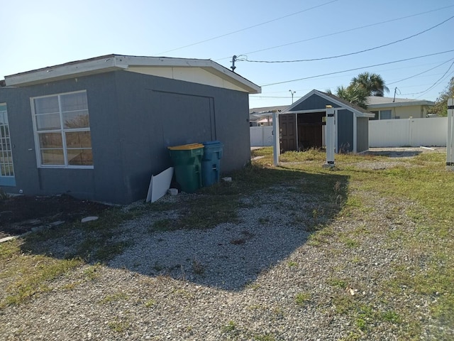 view of property exterior featuring a shed