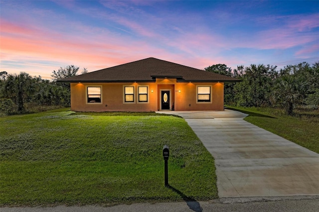 397 Doniphan Dr, Port Charlotte, FL 33954 - view of front of property featuring concrete driveway, a lawn, and stucco siding