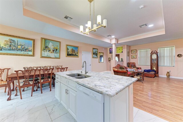 397 Doniphan Dr, Port Charlotte, FL 33954 - kitchen with white dishwasher, a tray ceiling, a sink, a chandelier, and open floor plan