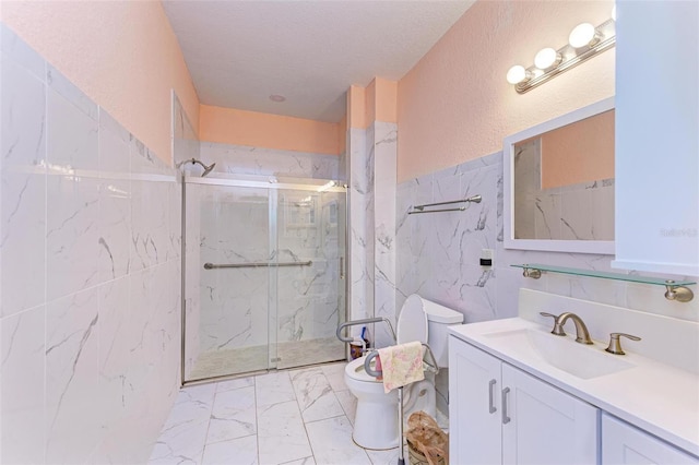 bathroom with a textured ceiling, vanity, toilet, and a shower with shower door