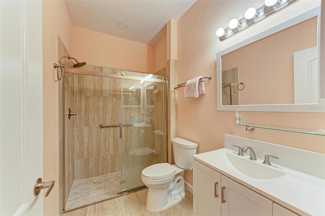 bathroom featuring hardwood / wood-style floors, vanity, toilet, and an enclosed shower