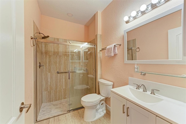397 Doniphan Dr, Port Charlotte, FL 33954 - bathroom with a textured wall, toilet, a shower stall, vanity, and wood finished floors