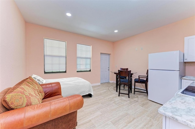 397 Doniphan Dr, Port Charlotte, FL 33954 - bedroom featuring freestanding refrigerator, light wood-type flooring, recessed lighting, and baseboards