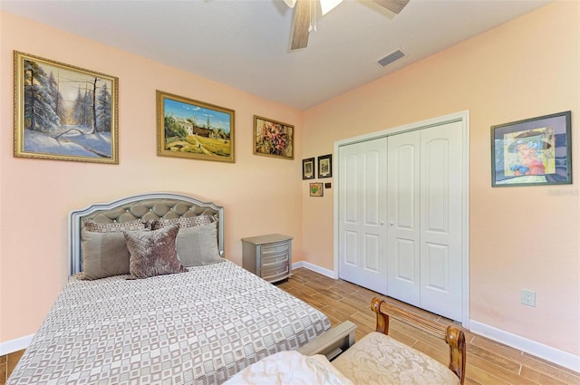 bedroom with wood-type flooring, a closet, and ceiling fan