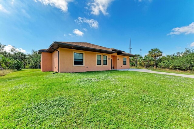 397 Doniphan Dr, Port Charlotte, FL 33954 - view of front facade featuring stucco siding and a front yard