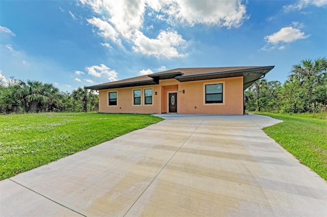 397 Doniphan Dr, Port Charlotte, FL 33954 - view of front facade with driveway, stucco siding, and a front lawn